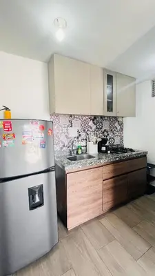 a kitchen with a stainless steel refrigerator and a sink at Apartamento Ideal cerca de Zona Industrial, Terminal y Centro Comercial in Cartagena de Indias