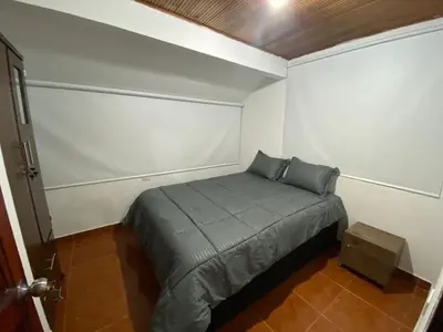 a small bedroom with a bed in a room at Modern duplex 5 minutes from the Historic Center in Cartagena de Indias