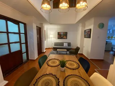 a dining room with a wooden table and chairs at Modern duplex 5 minutes from the Historic Center in Cartagena de Indias