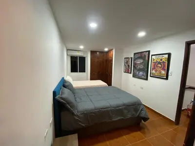 a small bedroom with a bed in a room at Modern duplex 5 minutes from the Historic Center in Cartagena de Indias