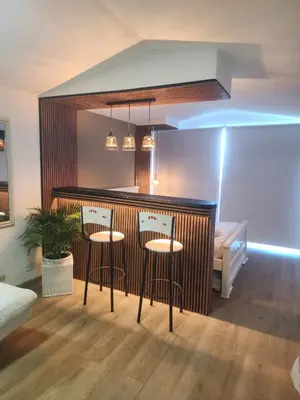a kitchen with three bar stools in a room at Lindo estudio con espectacular vista in Cartagena de Indias