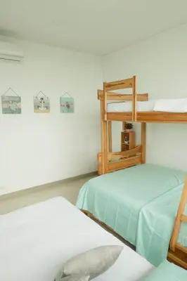 two bunk beds in a room with white walls at Amari Ocean House in Coveñas