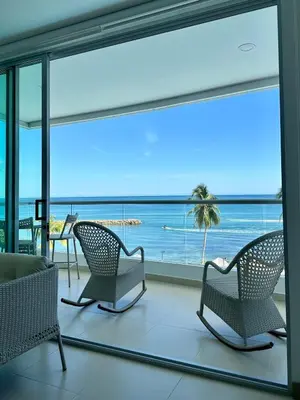 a room with chairs and a view of the ocean at Amari Ocean House in Coveñas