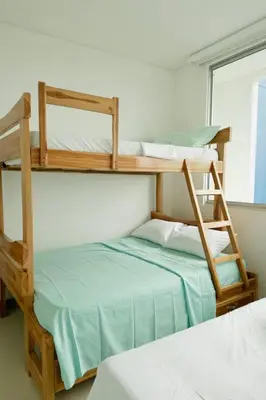 two bunk beds in a room with a bed at Amari Ocean House in Coveñas