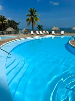 a swimming pool with a view of the ocean at Amari Ocean House in Coveñas