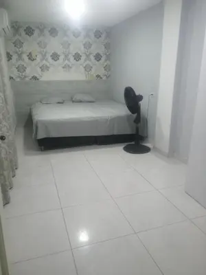 a bedroom with a bed and a chair in it at Rey SALOMÓN SALJA in Barranquilla