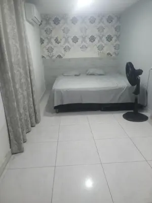 a bedroom with a bed and a white tiled floor at Rey SALOMÓN SALJA in Barranquilla