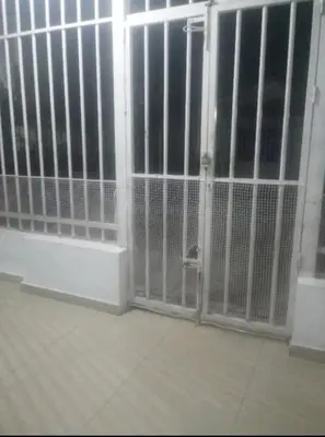 a room with a door with bars on it at Rey SALOMÓN SALJA in Barranquilla