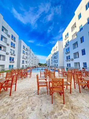 a row of chairs on a beach next to buildings at Mirador de la Reserva Coveñas in Coveñas