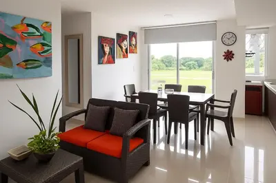 a kitchen and dining room with a table and chairs at Mirador de la Reserva Coveñas in Coveñas