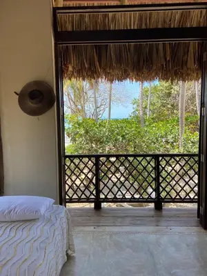 a bedroom with a bed and a window with a view at Villa Frente al mar en el Calao, San Antero in Calao