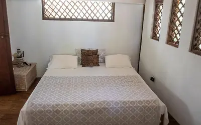 a bedroom with a bed in a white room at Villa Frente al mar en el Calao, San Antero in Calao