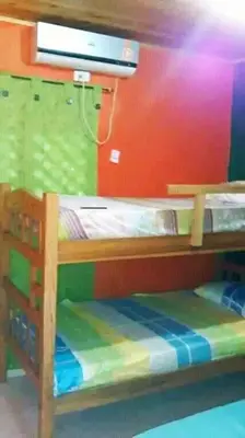 a bunk bed in a room with a colorful wall at Playas el paraiso in San Bernardo del Viento