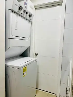 a white refrigerator in a kitchen next to a door at Apartamento en Cartagena con balcón en Morros in Cartagena de Indias