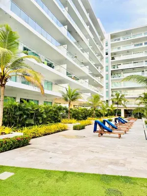 a row of beach chairs in front of a large building at Apartamento en Cartagena con balcón en Morros in Cartagena de Indias