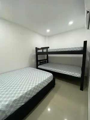 two bunk beds in a room with white walls at Apartamento 9 pax En Cartagena in Cartagena de Indias