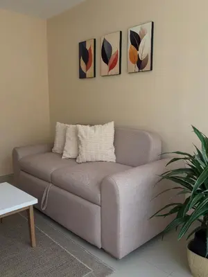 a couch in a living room with paintings on the wall at Apartamento en la mejor zona de Barranquilla in Barranquilla