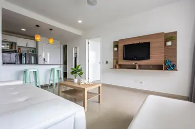 a living room with a bed and a tv on a wall at 224 - Morros Epic Acceso Directo a Playa in Cartagena de Indias