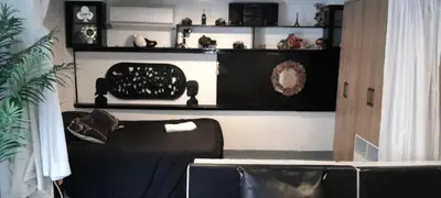 a living room with a black couch and shelves at apartamento 3 habitaciones totalmente equipado in Cartagena de Indias