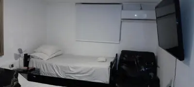 a small room with a bed and a flat screen tv at apartamento 3 habitaciones totalmente equipado in Cartagena de Indias
