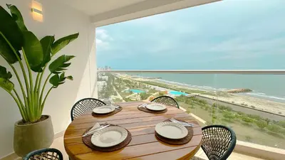a dining room table with a view of the beach at Charming Oceanfront Apartment with Balcony and Panoramic view, Cartagena Colombia in Cartagena de Indias
