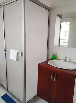 a bathroom with a sink and a shower with a mirror at apto en casa centro historico 3 piso in Cartagena de Indias