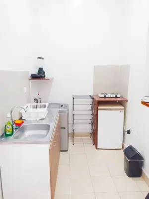a small kitchen with a sink and a refrigerator at apto en casa centro historico 3 piso in Cartagena de Indias