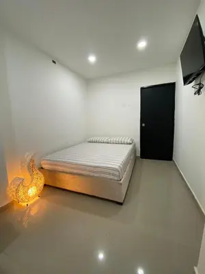 a bedroom with a bed and a flat screen tv at Habitación Privada en La Boquilla in Cartagena de Indias