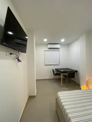 a room with a bed and a table with a projector at Habitación Privada en La Boquilla in Cartagena de Indias