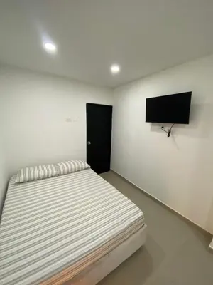 a bedroom with a bed and a flat screen tv at Habitación Privada en La Boquilla in Cartagena de Indias