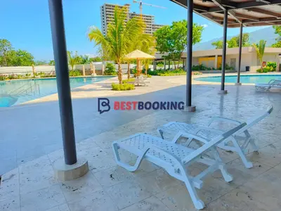 two white chairs sitting next to a swimming pool at Santa Marina Luxury Stay - Ocean View in Estación El Salto