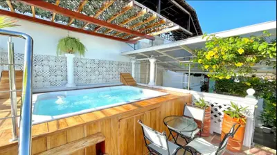 a hot tub in a patio with chairs and tables at Casa Mary Hotel in Cartagena de Indias