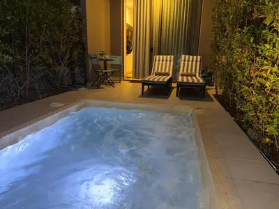 a hot tub in the middle of a patio with two chairs at Apartaestudio con Jacuzzi Privado y Vista al Mar in Cartagena de Indias
