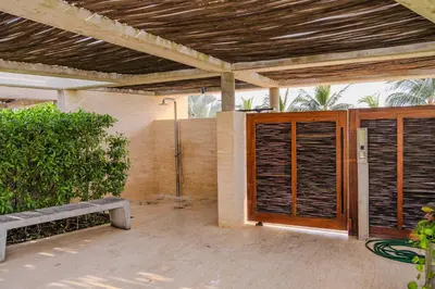 a patio with a wooden door with blinds on it at Apartaestudio con Jacuzzi Privado y Vista al Mar in Cartagena de Indias