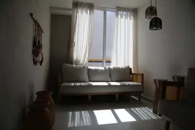 a living room with a couch in front of a window at Enjoy the sun and beach in our apartment in Cartagena de Indias