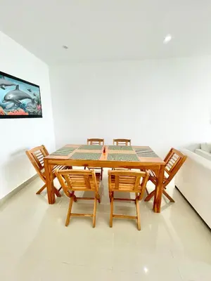 a dining room with a table and four chairs at Apto espectacular frente al mar in Coveñas