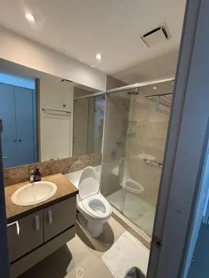 a bathroom with a toilet and a sink and a shower at Apto con playa, hotel y piscina in Santa Marta