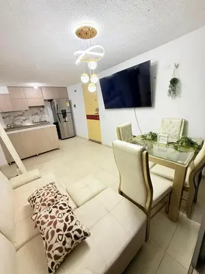 a living room with a table and a couch at Habitación 1 persona cerca de aeropuerto,terminal de buses y estadio in Soledad