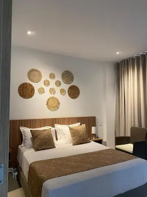 a bedroom with a bed with plates on the wall at Cartagena Baia kristal Getaway in Cartagena de Indias