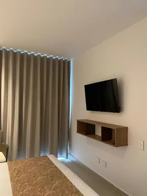 a bedroom with a flat screen tv on the wall at Cartagena Baia kristal Getaway in Cartagena de Indias