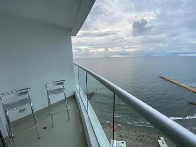 a balcony with two chairs and a view of the ocean at Apartamento Palmetto Eliptic 23 ICDI in Cartagena de Indias