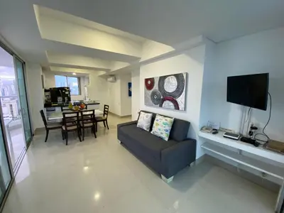 a living room with a couch and a table at Apartamento Palmetto Eliptic 23 ICDI in Cartagena de Indias