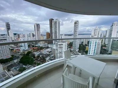 a balcony with a white table and chairs and a city at Apartamento Palmetto Eliptic 23 ICDI in Cartagena de Indias