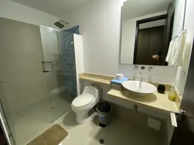 a bathroom with a toilet and a sink and a shower at Apartamento Palmetto Eliptic 23 ICDI in Cartagena de Indias
