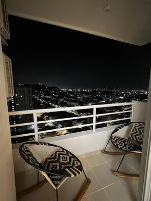 a balcony with two chairs and a view of the city at Alma Kalamari 24 in Cartagena de Indias