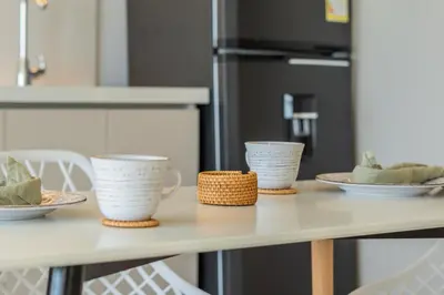 a table with three cups and plates on it at Charming Seafront Loft in Cartagena de Indias