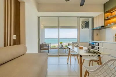 a kitchen and living room with a view of the ocean at Charming Seafront Loft in Cartagena de Indias