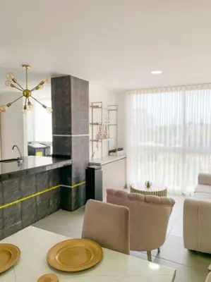a kitchen and living room with a table and chairs at Espacioso Apto Moderno! Excelente Ubicación Norte de Barranquilla in Barranquilla