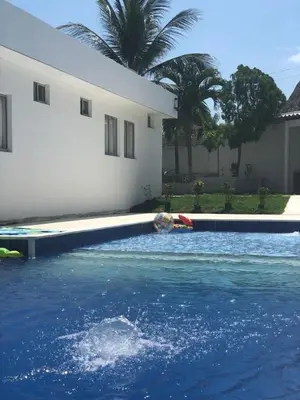 a person swimming in a swimming pool at Espectacular casa, vista al mar y piscina privada in Santa Veronica