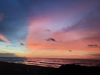 a sunset on the beach with the ocean at San Bernardo del Viento Cabaña La Isabela in San Bernardo del Viento